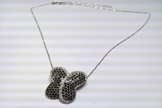 White gold yarn with butterfly pendant in black and white diamonds